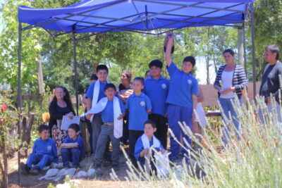 Niños bajo un toldo en evento ambiental de Escuela Corel